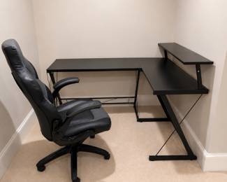 Open concept black corner desk and gaming desk chair