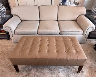 Light gray sofa. Leather tufted ottoman