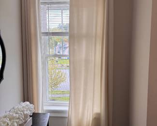Several ivory window curtains