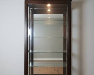 Dark Wood Curio Cabinet with Silver-Plated Serving Pieces and Porcelain Dinnerware