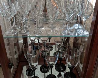 Vintage etched stemware and  pairs of black stemmed waters and wines.