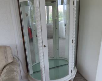 Bow front curio cabinet.