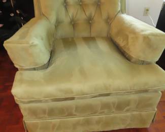 One of two velvet rocker swivel armchairs.