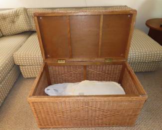 Wicker storage trunk/glass top coffee table.