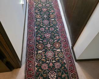 12'x32" handmade wool runner rug featuring a green background and Persian-style floral, excellent condition, no stains. 