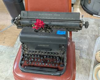 Vintage typewriters, silverplate serving pieces, and assorted household goods.