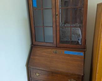 Vintage Jasper secretary desk with glass hutch, drop-front writing surface, cubbies, and drawers.
