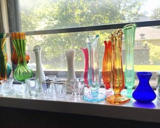 Assortment of colored bud vases, jar of marbles