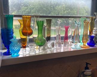 Assortment of colored bud vases, jar of marbles