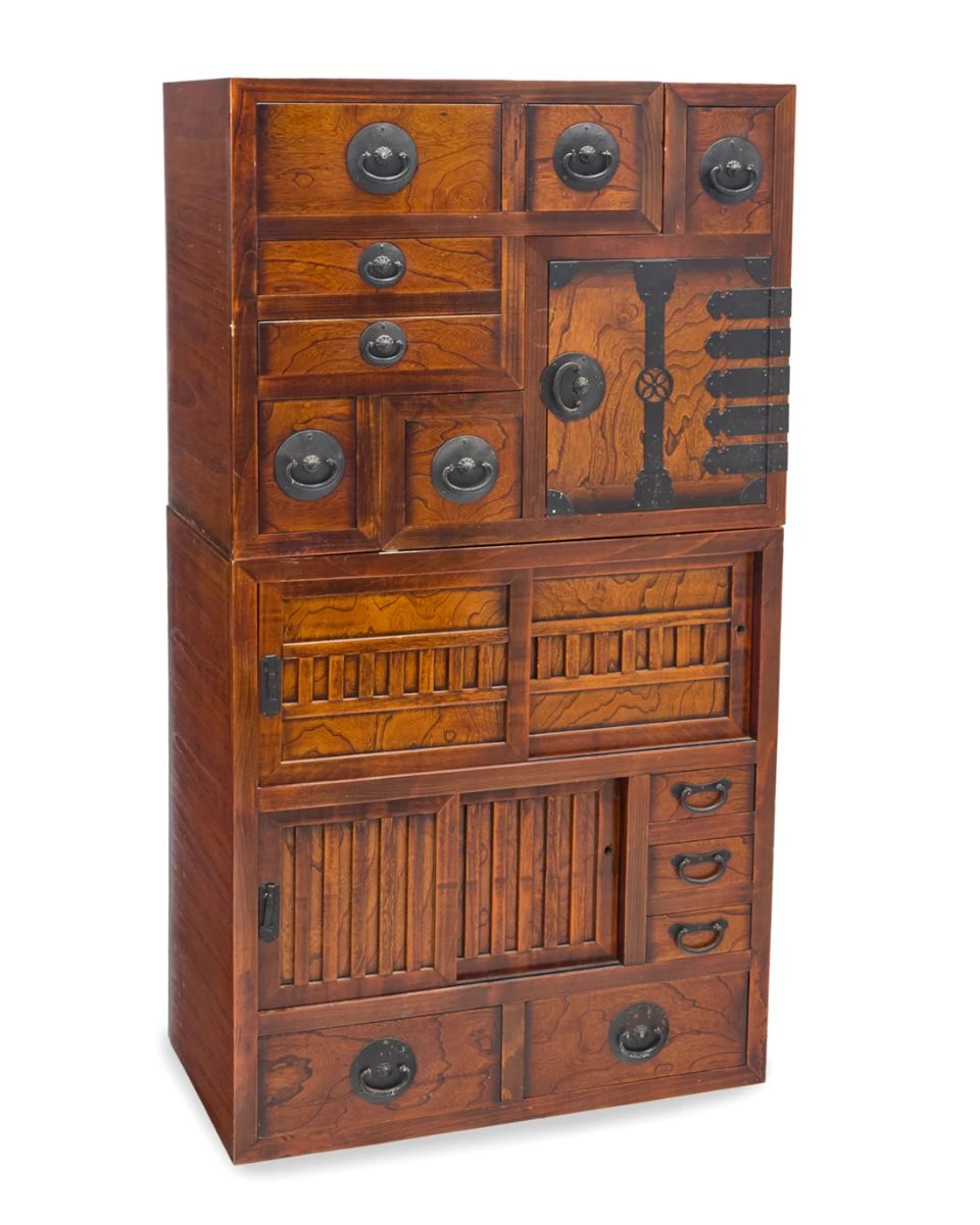 1001 A Japanese wood kaidan tansu 20th century The stepped or "staircase" chest with enameled metal hardware, the central console with two sliding door cabinets and five drawers, one stepped console with five drawers, the other with two drawers and a cabinet 3 pieces Central console: 35.5" H x 33.25" W x 18" D; Each stepped: 26.75" H x 25" W x 18" D Estimate: $800 - $1,200