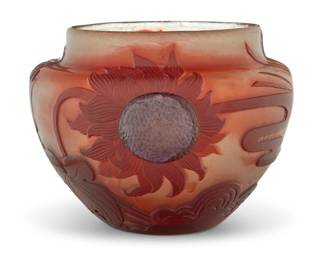 1102 An Émile Gallé wheel-carved cameo glass sunflower vase Circa 1900 Incised on underside: Gallé Deposé Fire polished, with foil inclusions, applied cabochon flower centers 6.125" H x 9" W x 8.125" D Estimate: $2,000 - $3,000