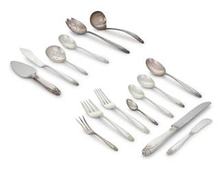 1223 An International sterling silver 'Prelude' flatware service Mid/late 20th century Designed 1939 Each marked for maker, pattern, and sterling Comprising: 4 place knives (9.625") 3 dinner knives (9.25") 9 luncheon knives (8.875") 10 butter spreaders (5.75") 1 dinner fork (8") 13 luncheon forks (7.375") 12 salad forks (6.625") 15 teaspoons (6") 7 cream soup spoons (6.625") 6 demitasse spoons (4.25") 2 serving spoons (8.5") 1 slotted serving spoon (8.5") 1 gravy ladle (6.5") 1 cheese knife (6.5") 1 master butter knife (7.25") 1 pickle fork (4.625") 1 bon bon spoon (4.75") 1 sugar spoon (5.875") 89 pieces Total weighable sterling: 82 oz. troy approximately Estimate: $3,000 - $5,000
