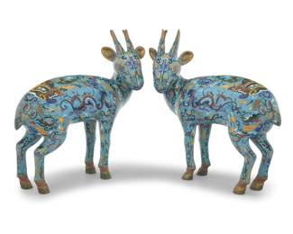 1349 A pair of Chinese cloisonné models of deer Late 19th/20th century Each deer cast in bronze, with brass and polychrome enamel depicting dragons, taotie masks, and filigree on a Jingtai blue ground 2 pieces Each: 15.75" H x 17" W x 6.75" D Estimate: $2,000 - $3,000