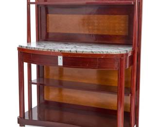 1111 A J. & J. Kohn inlaid beechwood server Model 3120 Designed circa 1903/1904 by Josef Hoffmann (1870-1956) or possibly Koloman Moser (1868-1918) With marquetry panels to backboard and finials, an upper shelf, a lower shelf with marble top above a single locking drawer over a narrow shelf and a curved bottom shelf, raised on cylindrical supports with metal sabots 66.5" H x 50.75" W x 25.75" D Estimate: $500 - $700
