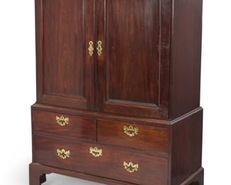 1379 A George III mahogany linen press Early 19th century The upper compartment with locking cabinet doors opening to reveal a later fabric-lined interior with single shelf and cut-outs at back for electrical, the lower compartment with three locking drawers, with later brass batwing escutcheons and lock plates Upper: 38.5" H x 47.5" W x 24" D; Lower: 27.75" H x 49.5" W x 25" D; Overall: 65.5" H Estimate: $500 - $700