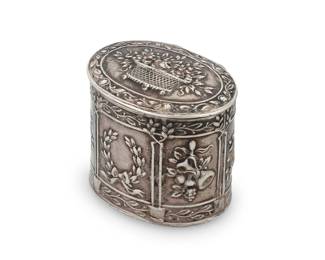 1240 A German Hanau .800 silver patch box Dingeldein Gebrüder, late 19th/early 20th century With impressed Hanau marks The sides with repoussé alternating friezes depicting laurel wreaths, wine bottles with grapes, and musical instruments, the lid decorated with flowers in a basket, the interior with gold wash 1.375" H x 1.375" W x 1.25" D 0.7 oz. troy approximately Estimate: $100 - $200