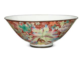 1010 A Chinese enameled porcelain centerpiece bowl Early 20th century or later Bearing a red underglaze reign mark for Qianlong Period (1736-1795) With millefleurs enameled exterior, the interior with bats centering a medallion, the rim and foot each mounted with metal trim 2.875" H x 7.25" Dia. Estimate: $1,000 - $1,500