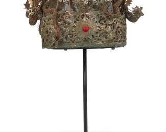 1127 A Chinese silver metal filigree wedding headdress Qing Dynasty (1644–1912) or later A large elaborate mixed metal wire and mesh crown with filigree border featuring dragon motifs and a central sunburst with set red stone, the top adorned with multiple sinuous dragons and long-tail roosters in metal foil and mesh, as well as floral and auspicious symbols, the crown mounted on a custom display stand 6.5" H x 10.5" W x 8.5" D (including decorations); Interior: 7.5" W x 6.75" D; 16.5" H on stand Estimate: $1,000 - $2,000