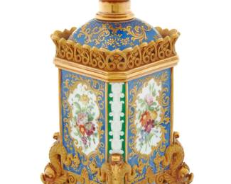 1184 A Jacob Petit porcelain scent bottle and stopper Jacob Petit (1797-1868), circa 1840 Signed in blue underglaze: JP With an openwork gallery to shoulder above the body painted with gilt foliate accents, each side decorated with painted flowers, raised on dolphin-form feet 9" H x 4.625" W x 4.625" D Estimate: $800 - $1,200