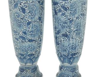 1004 A pair of Chinese blue and white porcelain ribbed trumpet vases Kangxi Period (1662-1722) Each profusely decorated with floral motifs 2 pieces Each: 10.5" H x 4.625" Dia. Estimate: $800 - $1,200