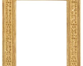 1068 A carved giltwood frame With floral motifs in relief and bead and barrel trim Inner: 23" H x 17.25" W; Outer: 31.375" H x 26" W x 2.5" D Estimate: $400 - $600