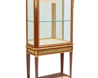 1078 A Louis XVI style gilt bronze mounted marquetry vitrine cabinet Paul Sormani (1817-1877), second half 19th century Marked to lock: PAUL SORMANI With bellflower and floral medallion diamond pattern marquetry, gilt-bronze laurel swags and bellflower trim, comprising an upper gallery above a glazed cabinet with locking door, single glass shelf and mirror back, and fabric-lined bottom and upper element, above a single locking drawer, raised on tapered legs joined by a shelf stretcher 67.25" H x 32.5" W x 13.5" D Estimate: $3,000 - $5,000