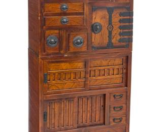 1001 A Japanese wood kaidan tansu 20th century The stepped or "staircase" chest with enameled metal hardware, the central console with two sliding door cabinets and five drawers, one stepped console with five drawers, the other with two drawers and a cabinet 3 pieces Central console: 35.5" H x 33.25" W x 18" D; Each stepped: 26.75" H x 25" W x 18" D Estimate: $800 - $1,200
