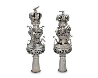 1243 A pair of Russian sterling silver Rimonim 19th century Each impressed: 1882 / 84 [zolotnik] / STERLING Each Torah scroll finial decorated with pierced and chased floral motifs, with dragon-form accents and bird finial, mounted with bells 2 pieces Taller: 15" H x 4" Dia. Total weight: 32.1 oz. troy approximately Estimate: $1,000 - $2,000