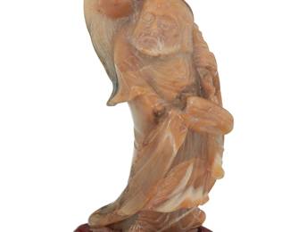 1167 A Chinese carved soapstone figure of a Bodhisattva Late Qing Dynasty/Republic Era (1644-1949) or later Possibly shoushan stone, with incised decorations to robe, raised on a carved wood base, housed in a cloth-lined wood box with padded interior Stone: 6.25" H x 3" W x 2.375" D; Overall: 6.75" H x 3.25" W x 2.75" D; Box: 3.5" H x 10" W x 7" D Estimate: $700 - $1,000