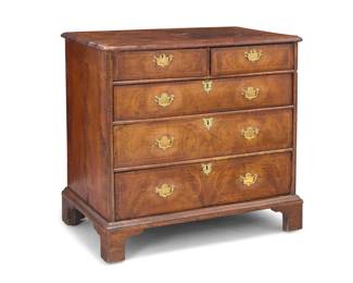 1352 A George I inlaid walnut chest of drawers Early 18th century with later elements The top with inlaid trim above two small drawers and three long locking drawers, each with later brass batwing escutcheons and lock plates, raised on bracket feet 36" H x 36.5" W x 22.5" D Estimate: $1,000 - $1,500