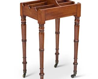 1332 A Louis XVI style rafraîchissoir 19th century With six cubbies for wine and liquor bottles, raised on turned legs with brass casters 33" H x 17.5" W x 13.5" D Estimate: $700 - $900