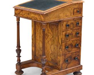 1338 A Gillows William IV Davenport desk Circa 1830s Impressed near lock: GILLOW & CO. With upper gallery and tooled leather inset to locking top opening to reveal four drawers, two false fronts, and a passementerie letter holder, with a side drawer housing pen and ink compartments, all above four locking drawers, with book matched burlwood veneer and fluted column supports, raised on gadrooned feet 30.5" H x 21" W x 24" D Estimate: $400 - $600