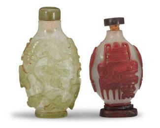 1130 Two Chinese glass overlay snuff bottles Qing Dynasty (1644-1912) Comprising a 'One Hundred Antiques' bottle with cinnabar-red over bubble glass, on a carved wood stand, and a green overlay bubble glass bottle carved with scrolling vines 2 pieces Green: 3.375" H x 1.875" W x 0.875" D; Red: 2.5" H x 1.625" W x 0.875" D Estimate: $1,200 - $1,800