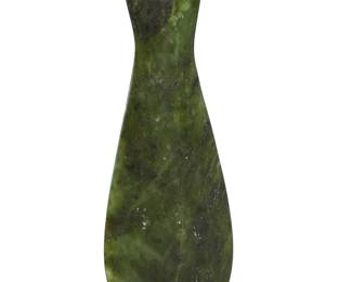 1169 A New Zealand mere pounamu 20th century, possibly Maori The nephrite jade short club with broad rounded blade tapering to a long handle incised with shallow grip ridges and with drilled suspension hole at end 8" H x 2.625" W x 0.75" D Estimate: $500 - $800