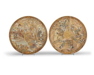 1185 Two Japanese Satsuma ceramic chargers 20th century Comprising one depicting three friezes with figural scenes, the other a 'One Hundred Boys' tableau, each with gilt moriage accents throughout 2 pieces Each: 2" H x 12.5" Dia. Estimate: $300 - $500