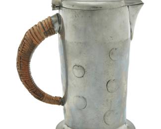 1106 An Archibald Knox for Liberty & Co. Tudric pewter lidded jug Early 20th century Impressed: 3 / MADE IN ENGLAND / "TUDRIC" / 0279 / RD421109 With hinged lid and rattan-wrapped wood handle 7.5" H x 5.375" W x 3.75" D Estimate: $200 - $300