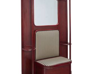 1110 A Josef Hoffmann for J. & J. Kohn beechwood coat stand Model 1080/2 Designed circa 1905 by Josef Hoffmann (1870-1956) With applied paper label verso: THONET / 60 With upper shelf, opposed coatracks, and lower umbrella/stick stands with metal liners, centered by a mirror and an upholstered bench with hinged seat opening to reveal a storage compartment Stand: 82" H x 47.5" W x 11" D; Seat: 43.75" H x 28" W x 18.5" D Estimate: $700 - $1,000