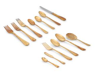 1229 A Tiffany & Co. gilt sterling silver 'Flemish' flatware service Mid-20th century Designed 1911 Each marked for Tiffany, sterling, and 'M' [directorship of John C. Moore (1907-1947)] Comprising: 8 dinner knives (10.125") 8 butter spreaders (6") 8 dinner forks (7.75") 8 luncheon forks (7") 8 salad forks (6.875") 8 oval soup spoons (7") 8 teaspoons (6") 8 demitasse spoons (4") 1 sugar spoon (5.75") 1 serving spoon (8.625") 1 serving fork (8.75") 1 casserole spoon (9.75") 1 tomato server (8") 69 pieces Total weighable sterling: 98.7 oz. troy approximately Estimate: $3,000 - $5,000
