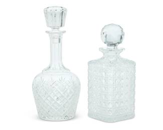 1342 Two Baccarat glass decanters Late 20th century Each with etched factory mark, one etched: CHIVAS Comprising a wine decanter and a whiskey decanter, each with stopper 2 pieces Wine: 11.25" H x 4.875" Dia.; Whiskey: 9.375" H x 3.875" W x 3.875" D Estimate: $300 - $500