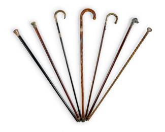 1241 A group of sterling silver mounted walking sticks 20th century Each marked for sterling, at least four with English hallmarks Comprising one natural wood, two ebonized wood, three carved wood, and one bamboo cane, each with a sterling-mounted accent or handle 7 pieces Longest: 36.75" L Estimate: $400 - $600
