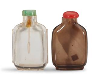 1138 Two Chinese rock crystal snuff bottles 19th/20th century Comprising one clear and one smoky quartz 2 pieces Clear: 3" H x 1.75" W x 0.75" D; Smoky: 2.875" H x 1.875" W x 0.75" D Estimate: $1,000 - $1,500