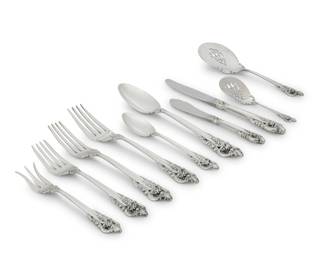 1235 A Wallace sterling silver 'Grand Baroque' flatware service Late 20th century Designed 1941 Each marked for maker and sterling Comprising: 12 dinner knives (9") 12 dinner forks (7.5") 12 salad forks (6.625") 12 teaspoons (6.25") 2 serving spoons (8.75") 1 serving fork (8.25") 1 master butter spreader (7") 1 lemon fork (5.625") 1 tomato server (8.125") 1 bon bon spoon (5.25") Together with 2 associated commemorative demitasse spoons 57 pieces Total weighable sterling: 71.6 oz. troy approximately Estimate: $1,200 - $1,800