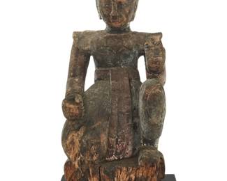 1013 A Khmer style carved wood Nat Likely 19th century Raised on an enameled wood base Figure: 19" H x 8.5" W x 8.5" D; Overall: 19.875" H x 10.125" W x 10.125" D Estimate: $300 - $500