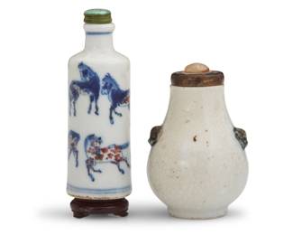 1147 Two Chinese porcelain snuff bottles Qing Dynasty (1644-1912) or later One depicting blue and iron red underglaze horses and raised on a carved wood stand, the other a simplified gourd form with opposed beast masks 2 pieces Horses: 3.5" H x 1.25" Dia.; Stand: 0.5" H x 1.125" Dia.; Gourd: 2.875" H x 1.875" Dia. Estimate: $800 - $1,200
