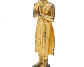 1157 A Southeast Asian gilt metal standing Buddha Likely Thai, 19th/20th century Painted and gilt, with hands in Wai position, mounted on a wood plinth Figure: 49" H x 14.5" W x 11" D; Overall: 58" H Estimate: $500 - $700