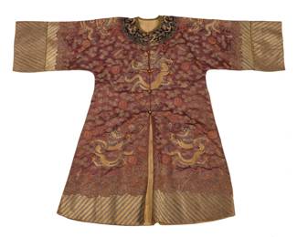 1356 A Chinese embroidered silk Dragon robe Late Qing dynasty or later An elaborately embroidered pale rosewood brown silk robe with striped sleeves and dark collar, featuring eight dragons surrounded by embroidered stylized clouds, and auspicious motifs and symbols, the hem and each wide sleeve with motifs depicting waves and deep water, with center front fastening, and lined in pale gold silk fabric 46" H x 24.5" W at underarms; sleeve cuff to collar: 27" L Estimate: $700 - $900