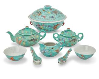 1025 A Chinese turquoise ground porcelain tea service First half 20th century Each bearing red reign mark for Qianlong Period (1736-1795); most stamped: CHINA With enameled butterfly and vine design, comprising: 1 teapot (4.5" H x 9.25" W x 6.375" D) 1 covered sugar (4.25" H x 7.375" W x 5.125" D) 1 creamer (3" H x 5.75" W x 4.625" D) Together with: 1 covered tureen (6.125" H x 9.875" Dia.) 7 spoons (4.875" L) 2 rice bowls (2.125" H x 4.625" Dia.) 13 pieces Estimate: $1,500 - $2,500