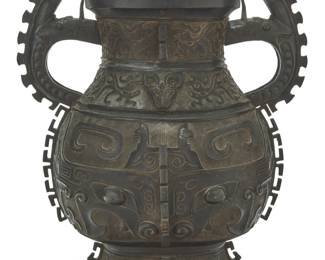 1011 A Chinese bronze archaistic hu vessel 20th century Decorated with taotie masks, phoenixes, and beast-form handles 19.25" H x 17.5" W x 13.25" D Estimate: $300 - $500