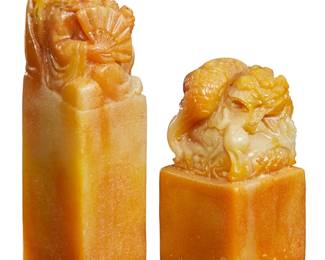 1166 Two Chinese carved shoushan stone seals 20th century The taller with incised inscription with landscapes and a pagoda Comprising a Luohan figure and a coiled dragon with flaming pearl 2 pieces Taller: 5.125" H x 1.5" W x 1.5" D; Shorter: 3.5" H x 1.75" W x 1.75" D Estimate: $700 - $900