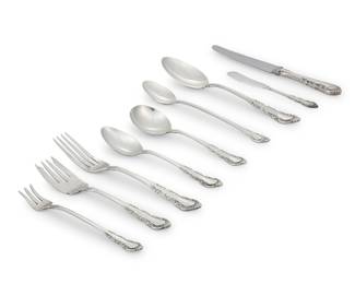 1226 A Reed & Barton sterling silver 'Georgian Rose' flatware service Mid-20th century Designed 1941 Each marked for maker and sterling Comprising: 12 dinner knives (9") 12 butter spreaders, monogrammed (6") 12 dinner forks (7.125") 12 salad forks (6.25") 12 cocktail/seafood forks (5.5") 17 teaspoons (6.125") 11 cream soup spoons (6") 7 iced tea spoons (7.75") 3 serving spoons (8.5") Together with an associated silver-plated butter spreader 99 pieces Total weighable sterling: 95.1 oz. troy approximately Estimate: $2,500 - $3,500